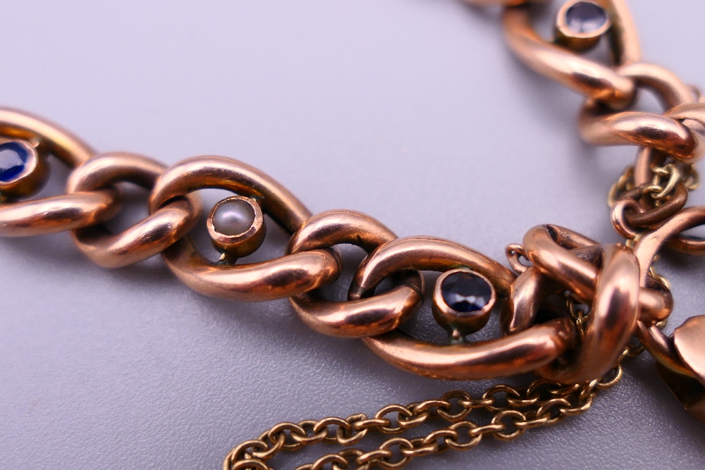 A 9 ct gold seed pearl and sapphire set bracelet with a 9 ct gold padlock. 19 cm long. 12. - Image 2 of 6