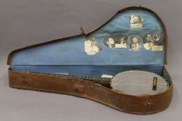 A cased banjo. The case 91.5 cm long.