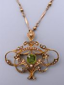 A 15 ct gold Art Nouveau pendant/brooch on a 9 ct gold chain. 4.5 cm wide. 14.