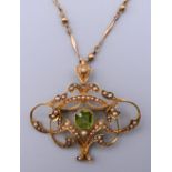 A 15 ct gold Art Nouveau pendant/brooch on a 9 ct gold chain. 4.5 cm wide. 14.