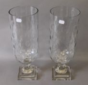 A pair of glass hurricane lamps. 40 cm high.