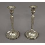 A pair of Continental white metal candlesticks. 23.5 cm high. 26.4 troy ounces weighted.