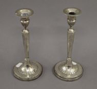 A pair of Continental white metal candlesticks. 23.5 cm high. 26.4 troy ounces weighted.