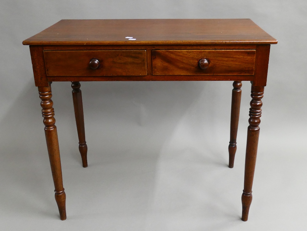 A Victorian mahogany two drawer side table. 86 cm wide, 47.5 cm deep, 76.5 cm high.