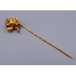 An unmarked gold dog form stick pin. 8.5 cm high.