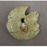 A jade roundel. 5 cm wide.