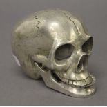 A Chatterbox metal skull. 9 cm high.