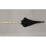 A 19th century parasol with Canton carved ivory handle. 69 cm long.