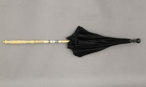 A 19th century parasol with Canton carved ivory handle. 69 cm long.