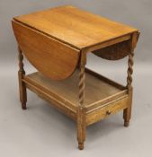 An early 20th century oak barley twist tea trolley. 61 cm long.