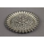 An Eastern embossed white metal pin tray. 11.5 cm diameter. 2.7 troy ounces.