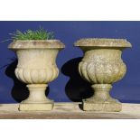 A small pair of marble urns. 31 cm high.