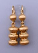 A pair of 14 K gold earrings. 2.5 cm high. 4.4 grammes.