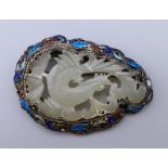 A silver, jade and enamel brooch. 5.5 cm wide.