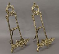 A pair of brass easels. 39.5 cm high.