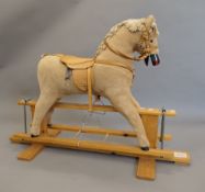 An Elf Toys rocking horse. 128 cm long.