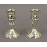 A pair of sterling silver candlesticks with detachable sconces. 13 cm high. 23.4 troy ounces loaded.