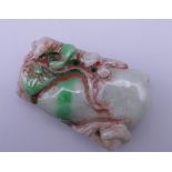 A carved jade pendant. 5.5 cm high.
