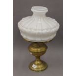 A Victorian brass oil lamp with opaline glass shade.