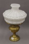 A Victorian brass oil lamp with opaline glass shade.