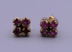 A pair of 18 ct gold and ruby earrings. Each 5 mm high.