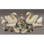 A collection of porcelain swans, ducks and chickens. Large swans 38 cm high, 36 cm long.