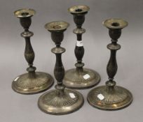 Four silver plated neo classical oval candlesticks. 29 cm high.