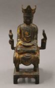 A bronze seated Chinaman. 32.5 cm high.