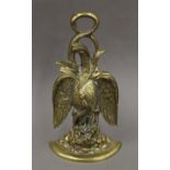 A brass eagle form door stop. 34 cm high.