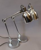 A pair of chrome anglepoise lamps