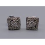 A pair of 18 ct white gold Art Deco style square diamond ear studs. 7 mm square.