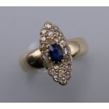 An antique 18 ct gold (tested) pave set diamond and sapphire navette shaped ring. Ring size P. 6.