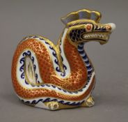 A Royal Crown Derby paperweight formed as a dragon.