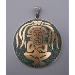 A large circular pendant with Aztec design inlaid with turquoise mosaic stamped .925, Mexico. 6.