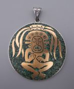 A large circular pendant with Aztec design inlaid with turquoise mosaic stamped .925, Mexico. 6.