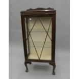 An early 20th century glazed display cabinet. 57 cm wide, 124 cm high, 29 cm deep.