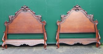 A pair of modern carved beds. 165 cm wide x 173 cm high.