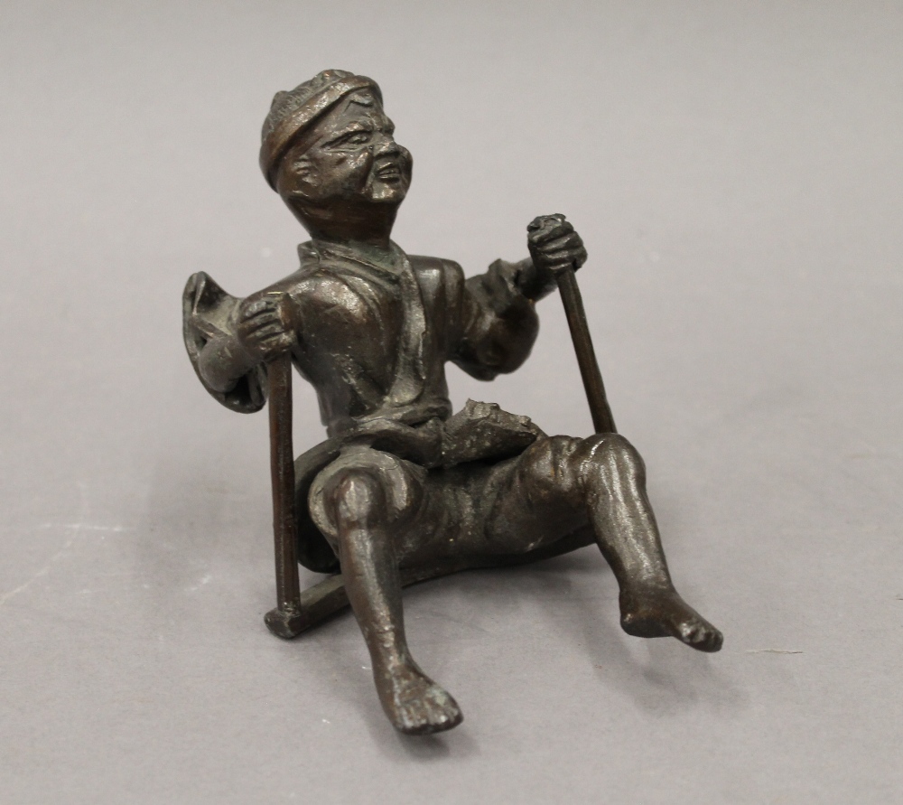 A Japanese bronzed metal figure. 18 cm high.