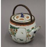 A 17th/18th century Chinese porcelain tea pot, with adapted handle. 13 cm high.