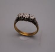 An 18 ct gold illusion set three stone diamond ring