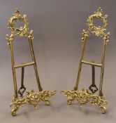 A pair of brass table easels. 41 cm high.