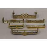 Six Victorian miniature brass fenders. The largest 17.5 cm wide.