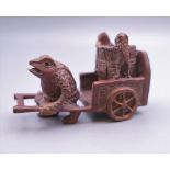 A Japanese model of a toad pulling a cart. 8 cm long.