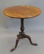 A 19th century mahogany tilt-top tripod table. 61 cm diameter.