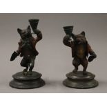 A pair of painted bronze fox form candlesticks. 16 cm high.
