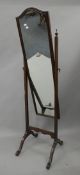 A mahogany cheval mirror. 158 cm high.