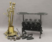 A brass stick stand, a set of brass fire irons and a cast iron fire side stand.