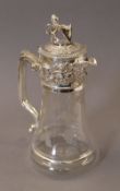 A silver plated lion top claret jug. 27 cm high.