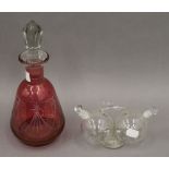 A cranberry glass decanter and a double clear glass vinaigrette. The former 27 cm high.