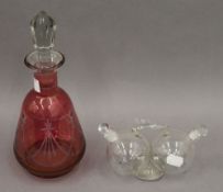 A cranberry glass decanter and a double clear glass vinaigrette. The former 27 cm high.